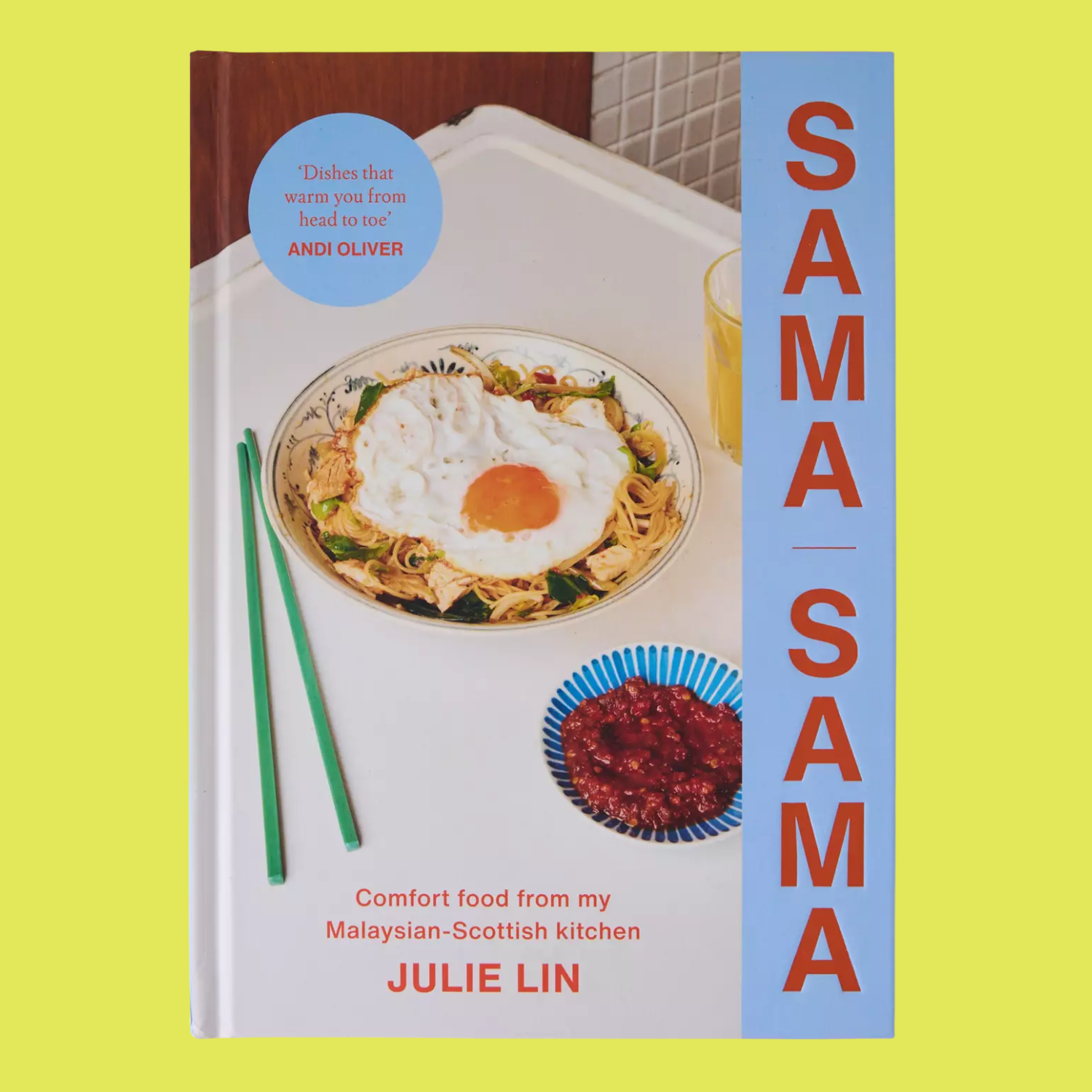 A colorful book with a plate of noodles with a fried egg and a bowl of sambal