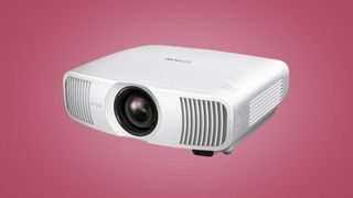 The Epson Home Cinema LS11000 laser projector on a pink void background