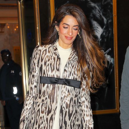 Amal Clooney wears a leopard coat with thigh-high boots