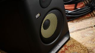 A KRK Rokit 5 G5 studio monitor on a rug