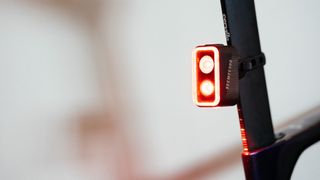 The SEEMEE 300 mounted on a bike seatpost showing the LEDs lit