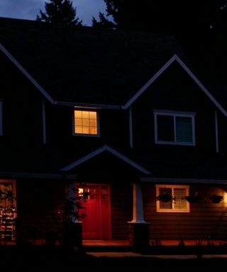 Exterior of a house at night with security lights on