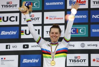 US Jennifer Valente celebrates her gold medal on the podium after winning the Womens Omnium event during the UCI Track Cycling World Championships at the Velodrome of SaintQuentinenYvelines southwest of Paris on October 14 2022 Photo by Thomas SAMSON AFP Photo by THOMAS SAMSONAFP via Getty Images