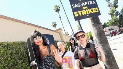 Jameela Jamil and Zoe Lister-Jones pose on the picket line outside of Warner Bros Studio in Burbank, California.