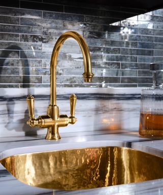 Brass sink in a marble kitchen