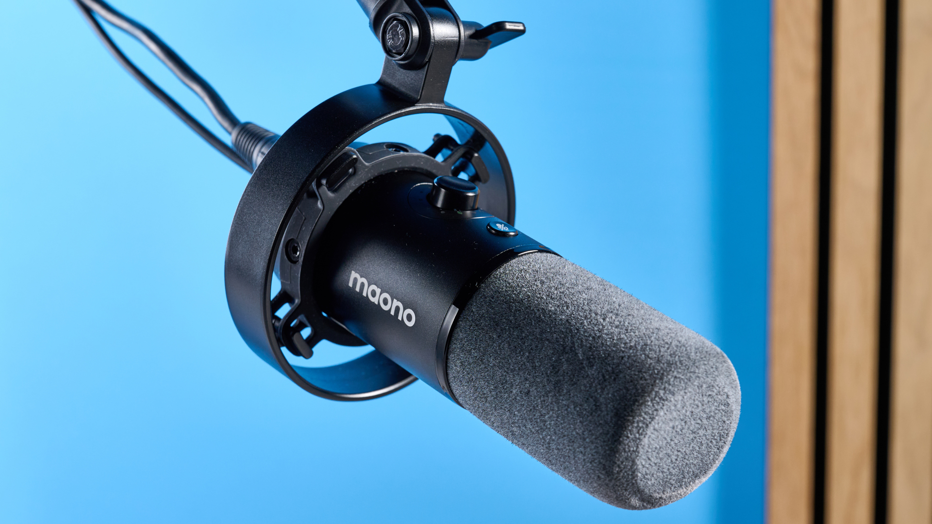 the maono pd1300x microphone for podcasting with an xlr and usbc connection and a boom arm in the photograph but also available with a desktop stand, one button dial on the mic and a muting button