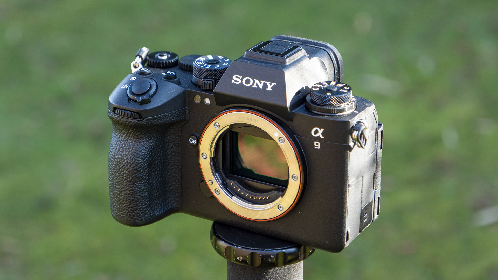 Sony A9 III camera outside with background foliage, no lens attached