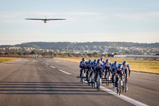 Red Bull-Bora-Hansgrohe riders pulling a plane to take-off in Mallorca