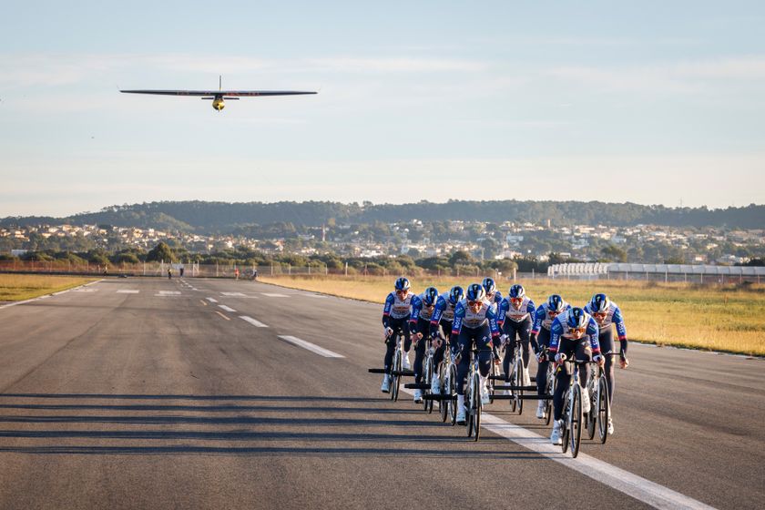 Red Bull-Bora-Hansgrohe riders pulling a plane to take-off in Mallorca