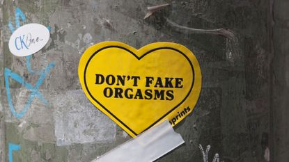 yellow heart-shaped sticker that says "Don't fake orgasms"