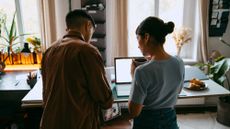 A young couple looking at a laptop