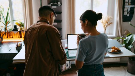 A young couple looking at a laptop