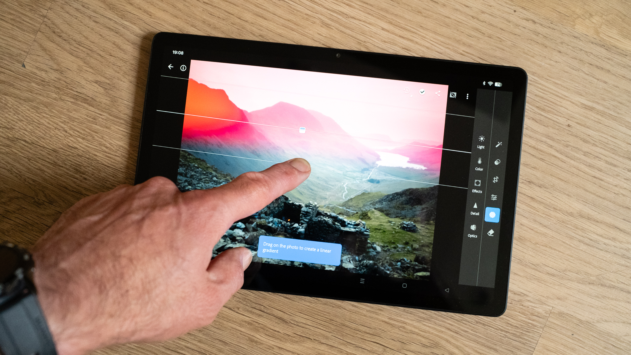Oppo Pad SE running Adobe Lightroom Mobile with a hand editing a photo