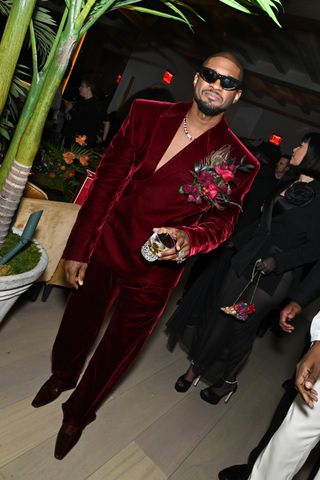 The person who opened the door was wearing a burgundy velvet suit