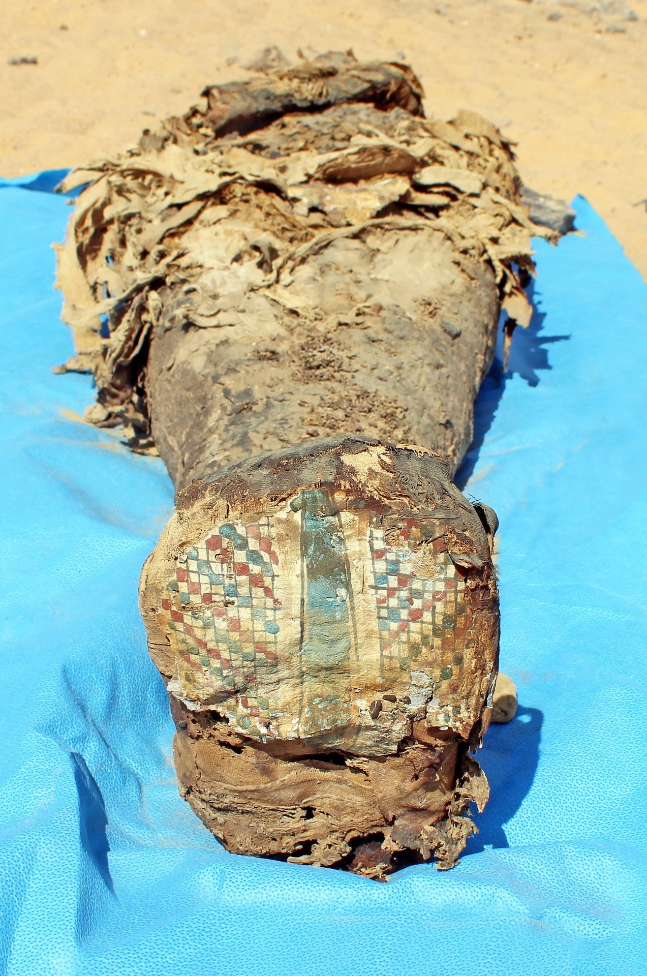 A mummy with cartonnage covering the feet.