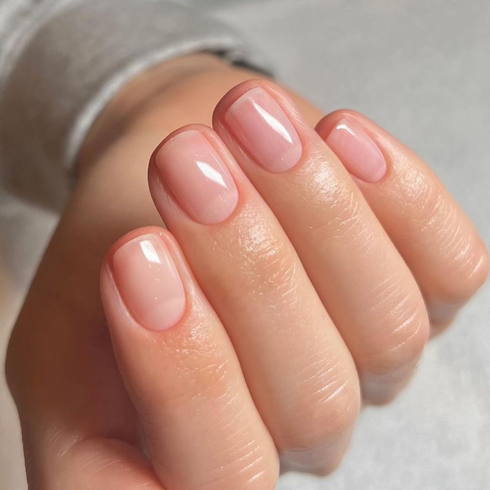 A close-up shot of a clear, glossy manicure