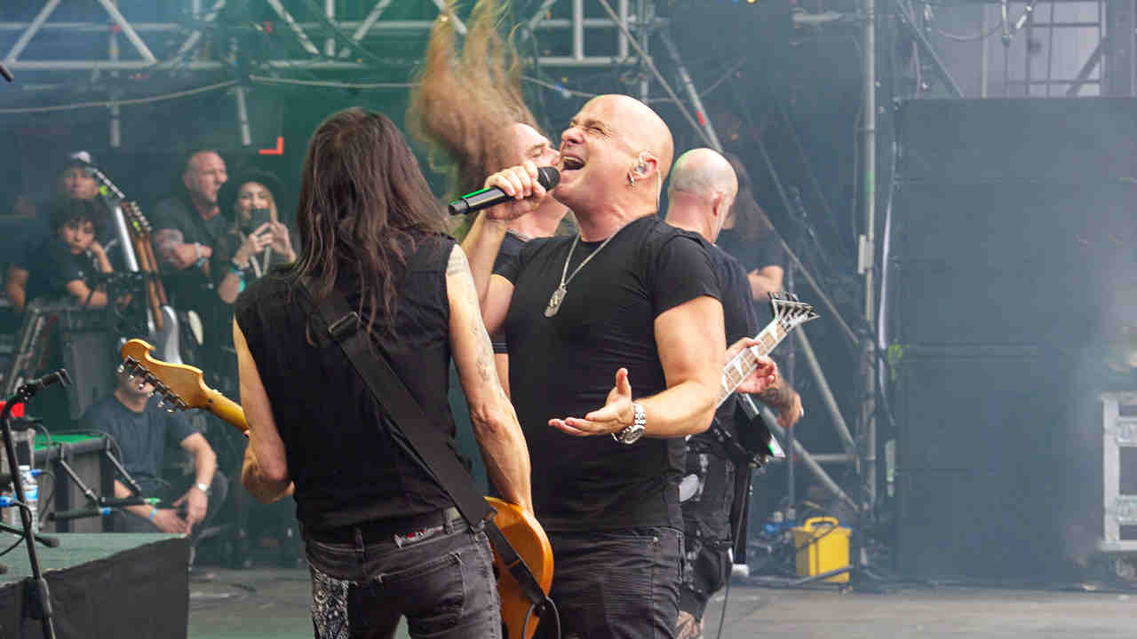 Disturbed’s David Draiman performing onstage at Black Sabbath and Ozzy Osbourne’s farewell gig