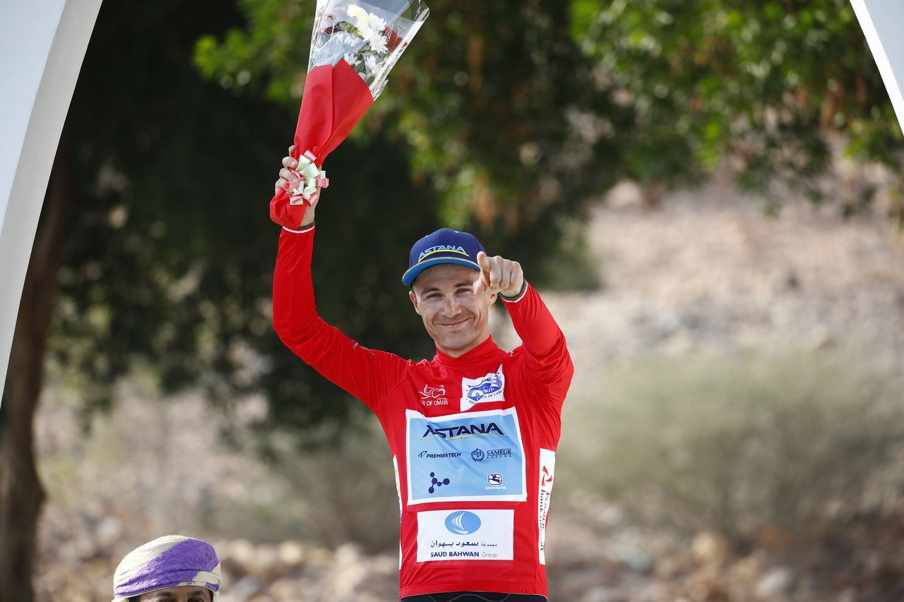 Alexey Lutsenko wears the red jersey