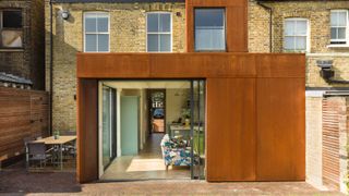 corten clad kitchen extension to terrace along party wall 