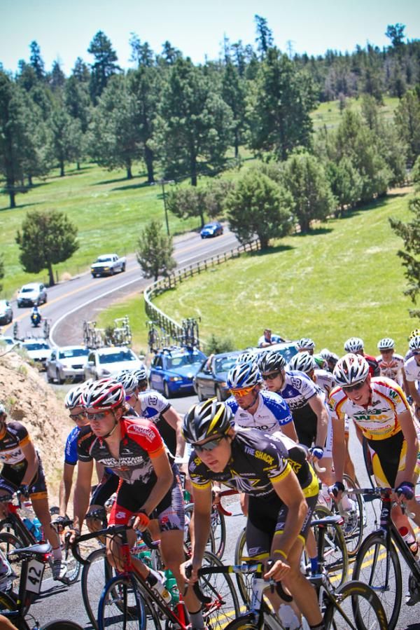 The convoy follows the riders over the winding course.