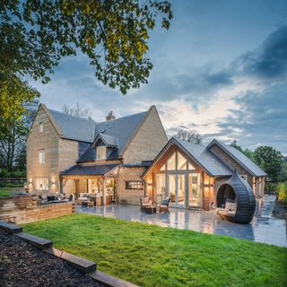 oak frame self build with stone cladding and glazed gable exterior