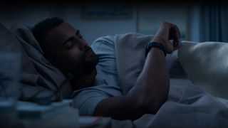 Man wearing Garmin Venu 2 Plus watch in bed