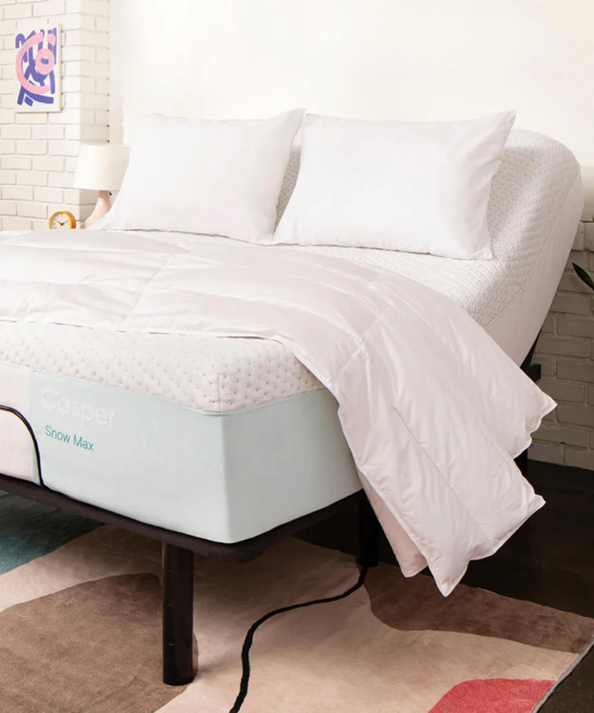 Adjustable bed frame with mattress, comforter and two pillows