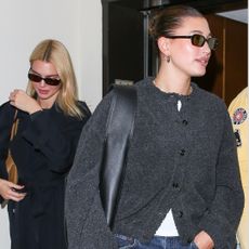 Hailey Bieber and Kendall Jenner leaving dinner at Sushi Park wearing a gray cardigan sweater