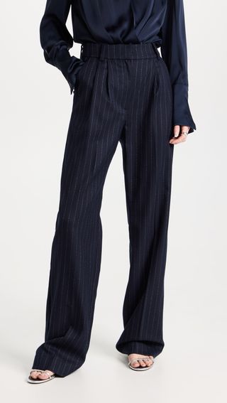 a model wears navy blue pinstripe pants