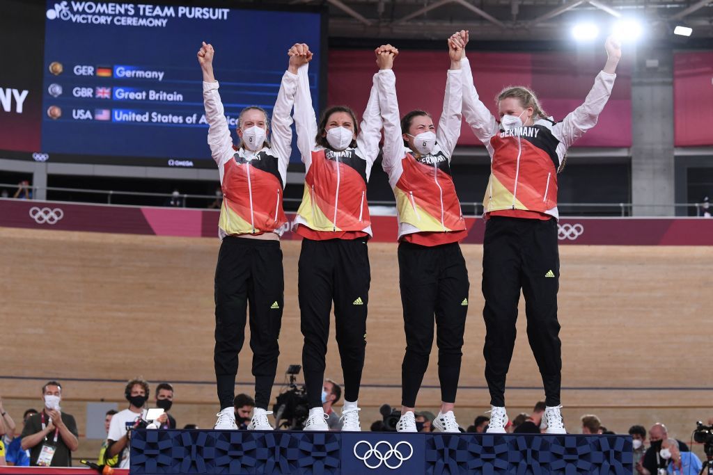 Gold medallist from L R Germanys Franziska Brausse Germanys Lisa Brennauer Germanys Lisa Klein and Germanys Mieke Kroger celebrates on podium during the medal ceremony for the womens track cycling team pursuit during the Tokyo 2020 Olympic Games at Izu Velodrome in Izu Japan on August 3 2021 Photo by Greg Baker AFP Photo by GREG BAKERAFP via Getty Images