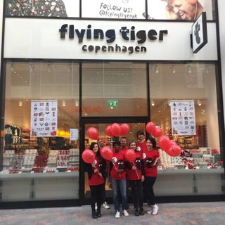 flying tiger store with staff and red balloon