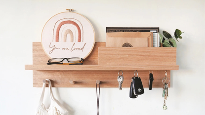 A wooden boho entryway storage organizer with embroidered hoop and accessories