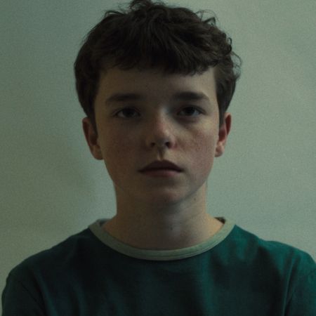 owen cooper as jamie as he stares into the camera in a still from adolescence 