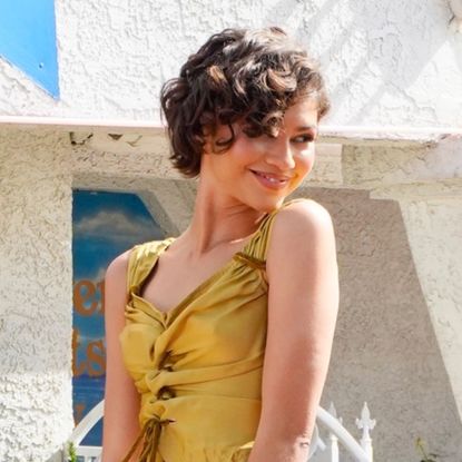 Zendaya wearing two very different Louis Vuitton looks, including a gold matching set and a white structural gown