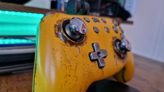 The PB Tails Crush Defender's silver thumbstick from the side