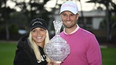 Alicia Bogdanski and Wyndham Clark with the trophy at the Pebble Beach Pro-Am
