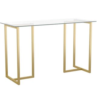 a glass desk with brass legs