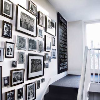 hallway with photo wall and stairs