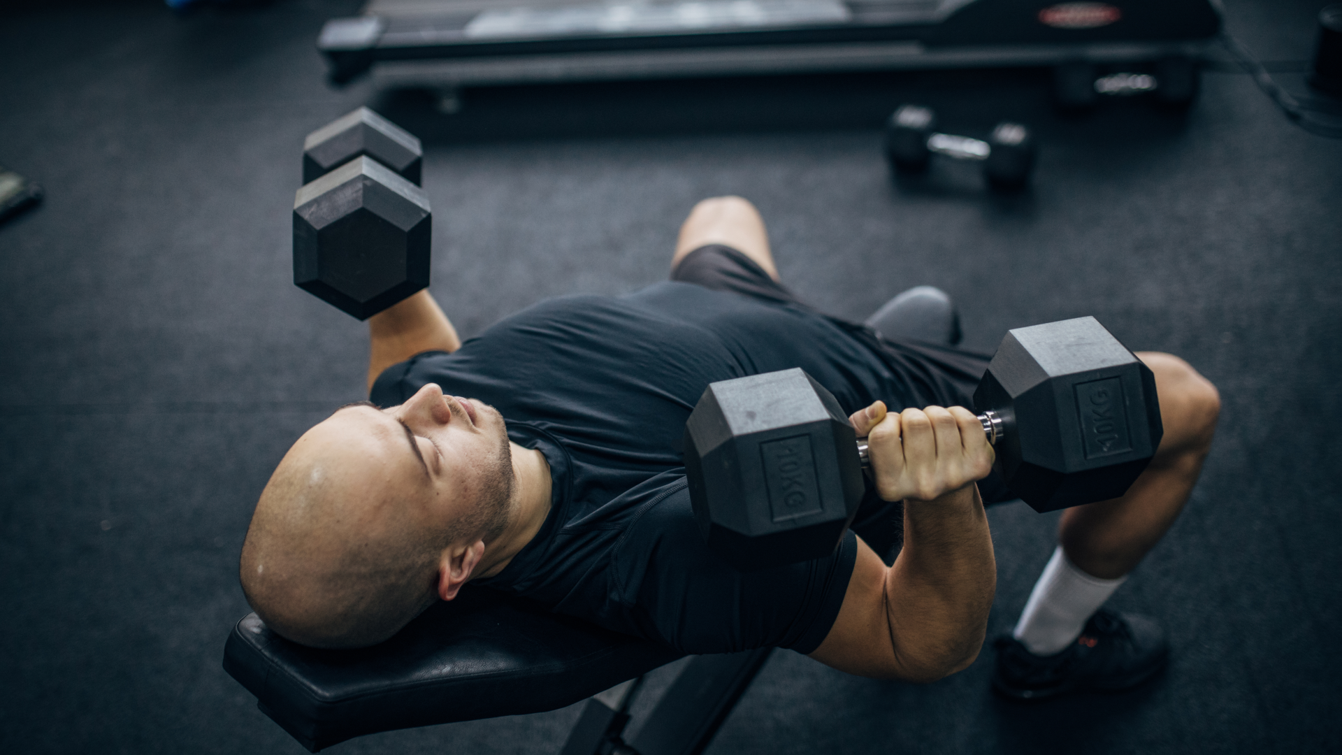 A man doing a dumbbell chest press