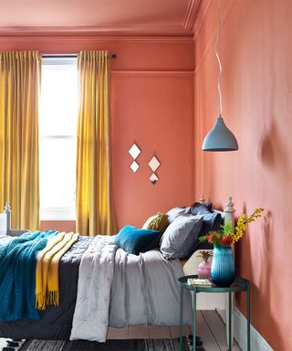 bedroom with yellow curtain and hanging lamp