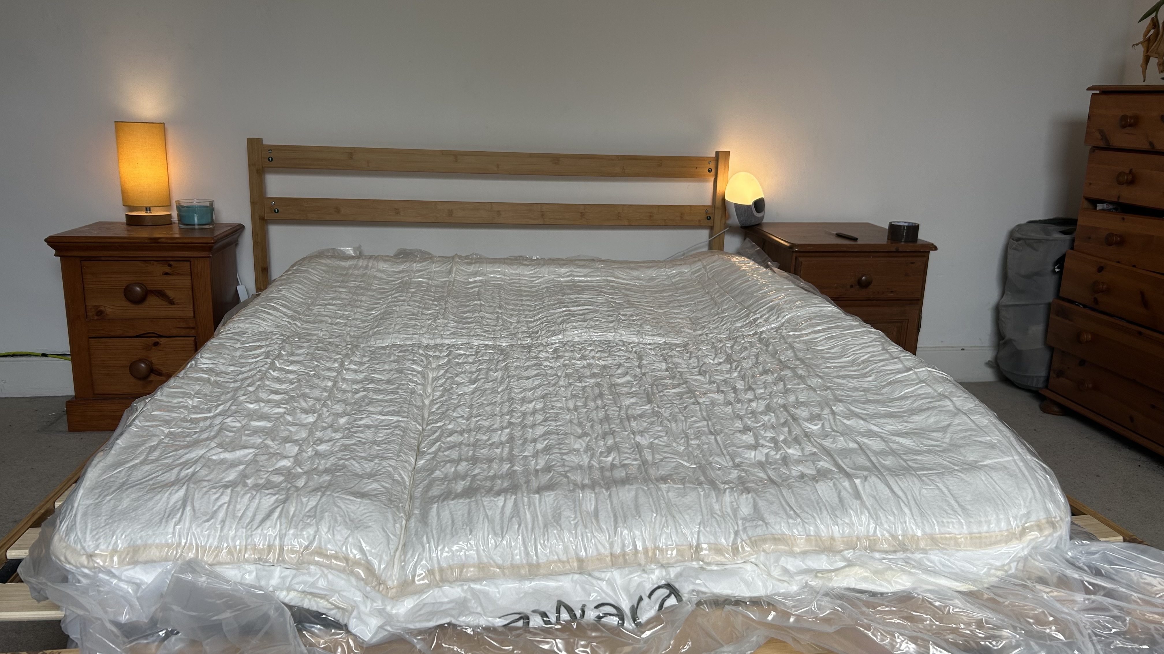 The Awara Classic packaged in plastic on a wooden bed frame