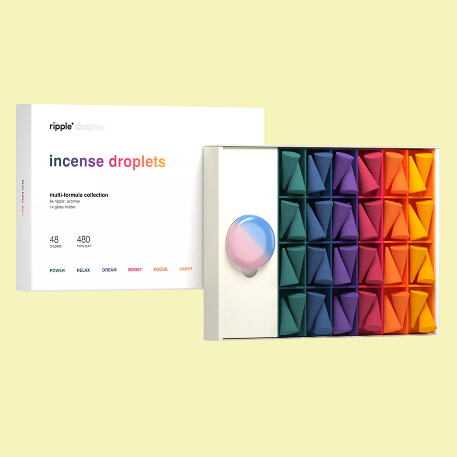 A box of colorful incense cones and a sea glass holder