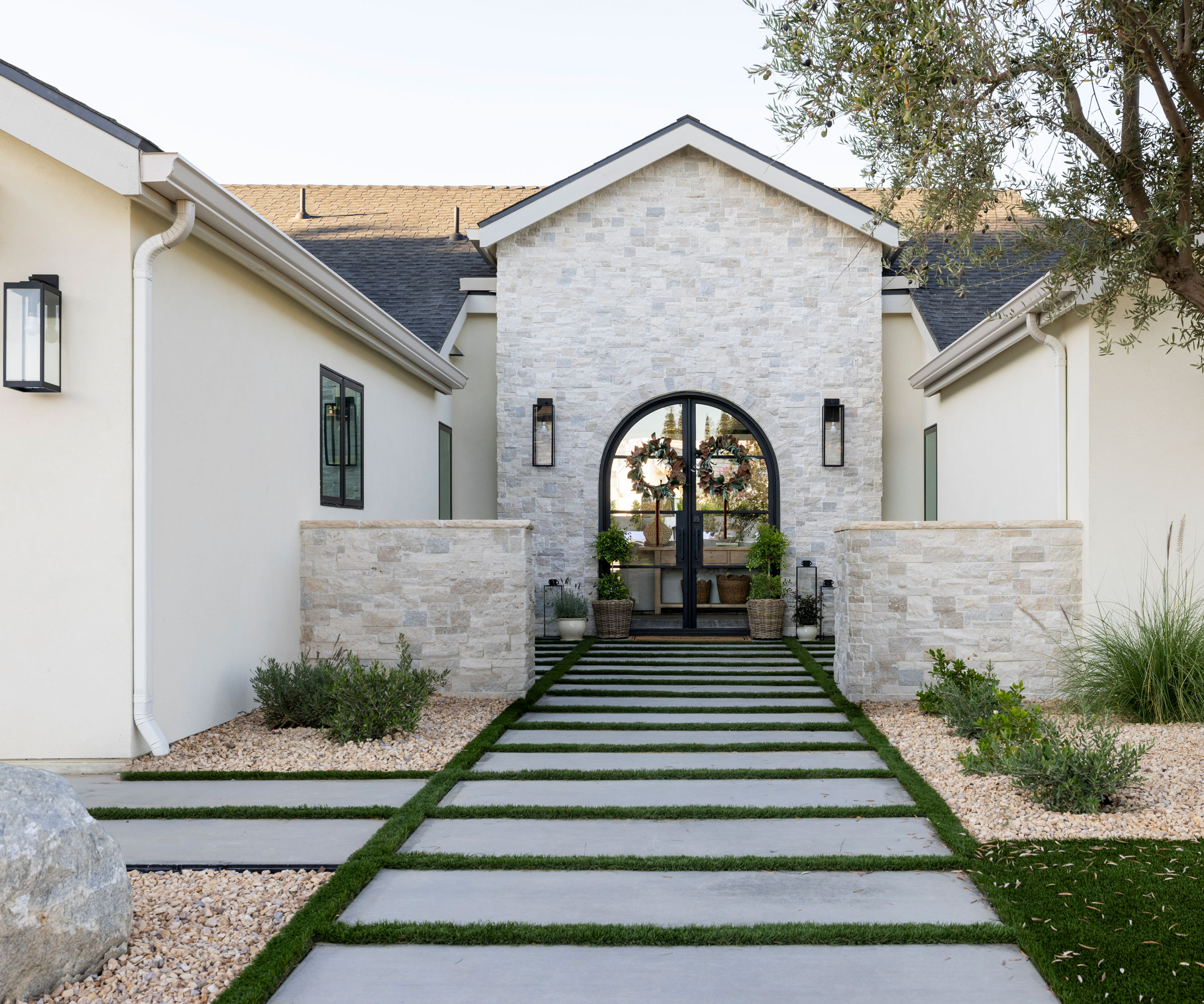 modern garden with minimal planting, gravel landscaping, and wide path with grass areas