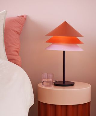 pink and red table lamp on nightstand