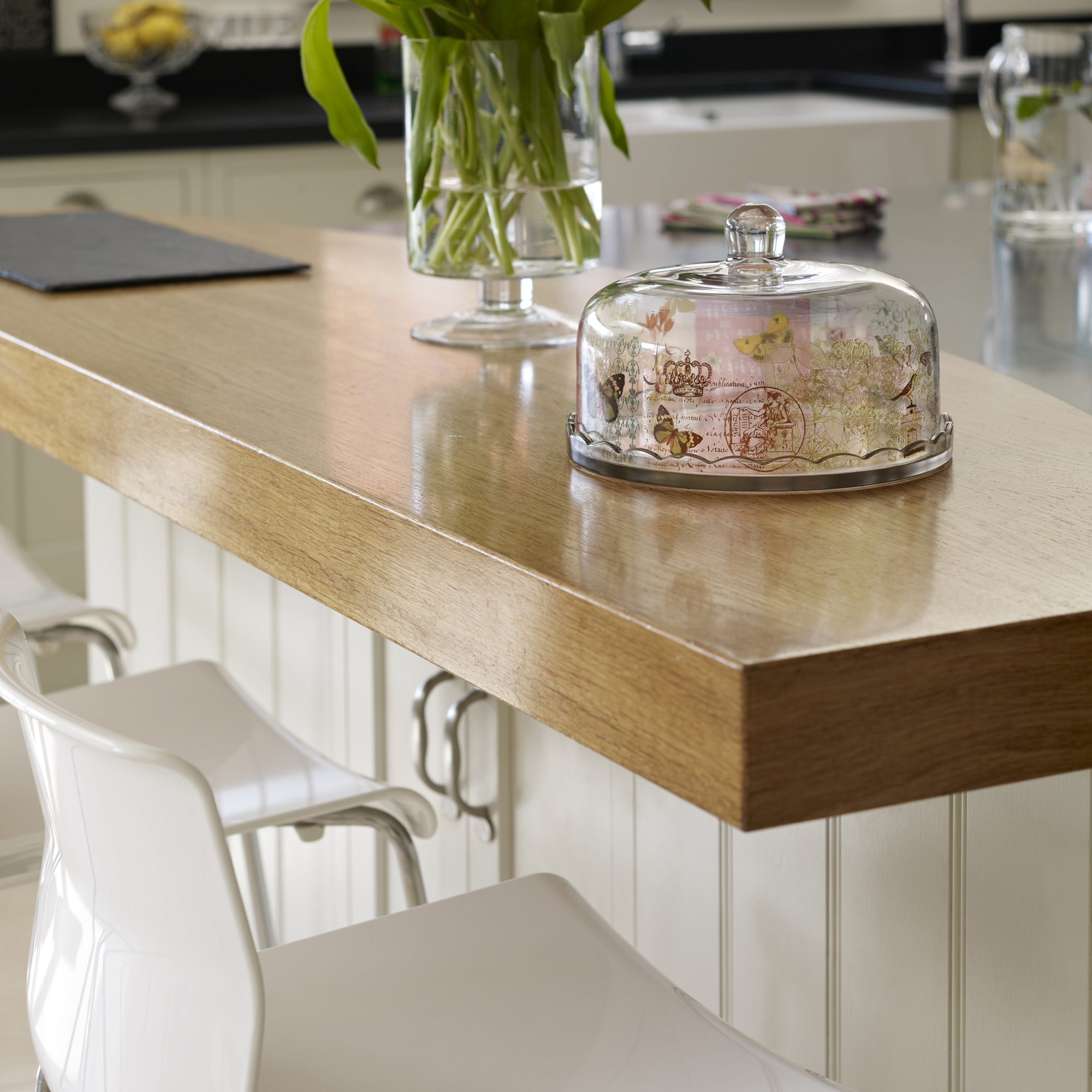 wooden bar top with white stools