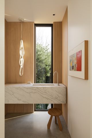 Bathroom with concrete floor and white and wood walls