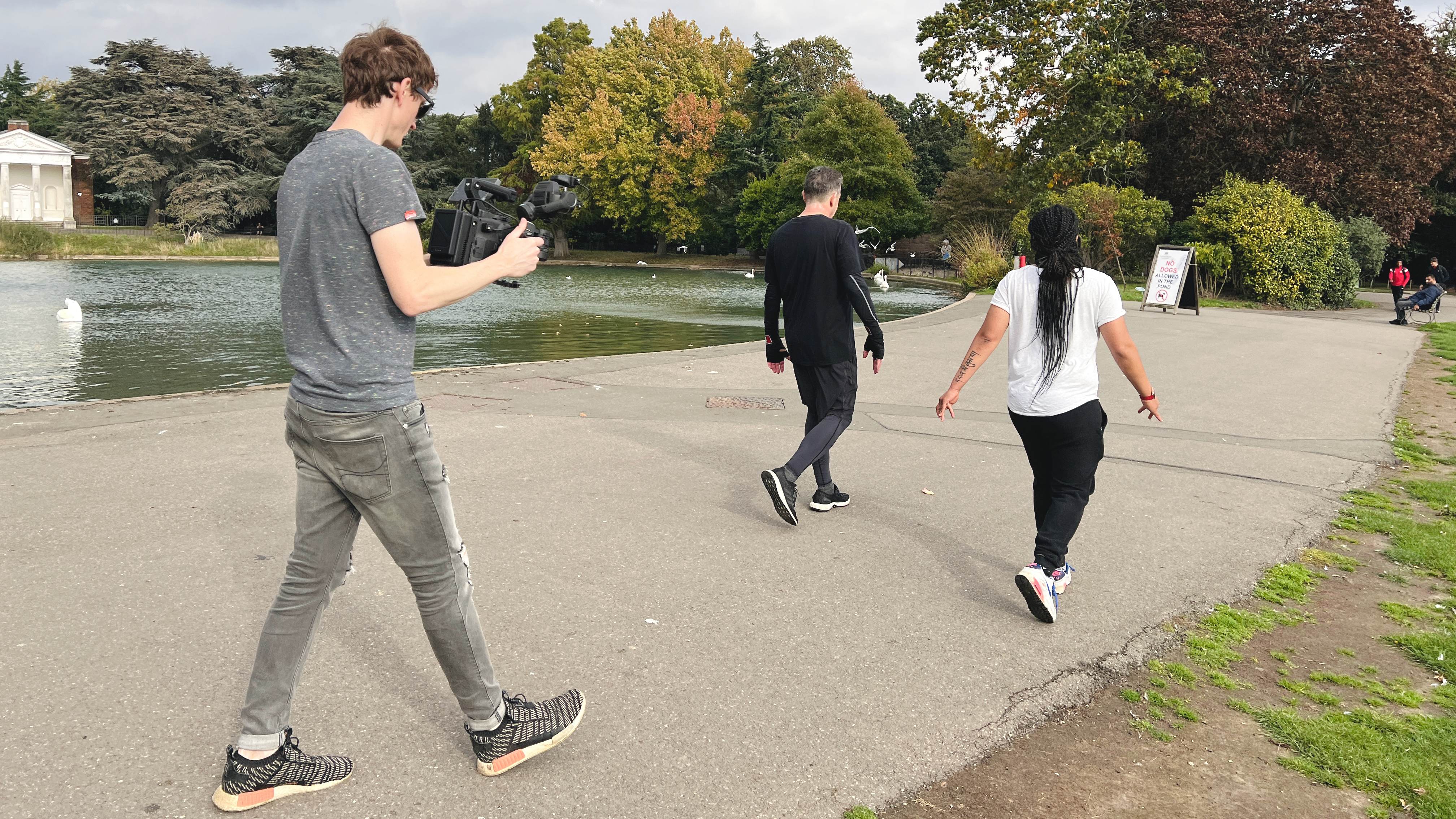 The DJI Ronin 4D being held by a filmmaker following two people