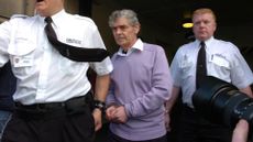 Peter Tobin being led away from court