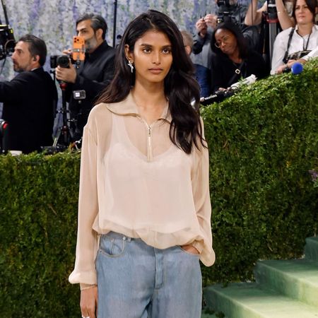 Model Bhavitha Mandava wears straight-leg jeans and a sheer polo top and Chanel two-tone heels on the Met Gala 2026 red carpet.
