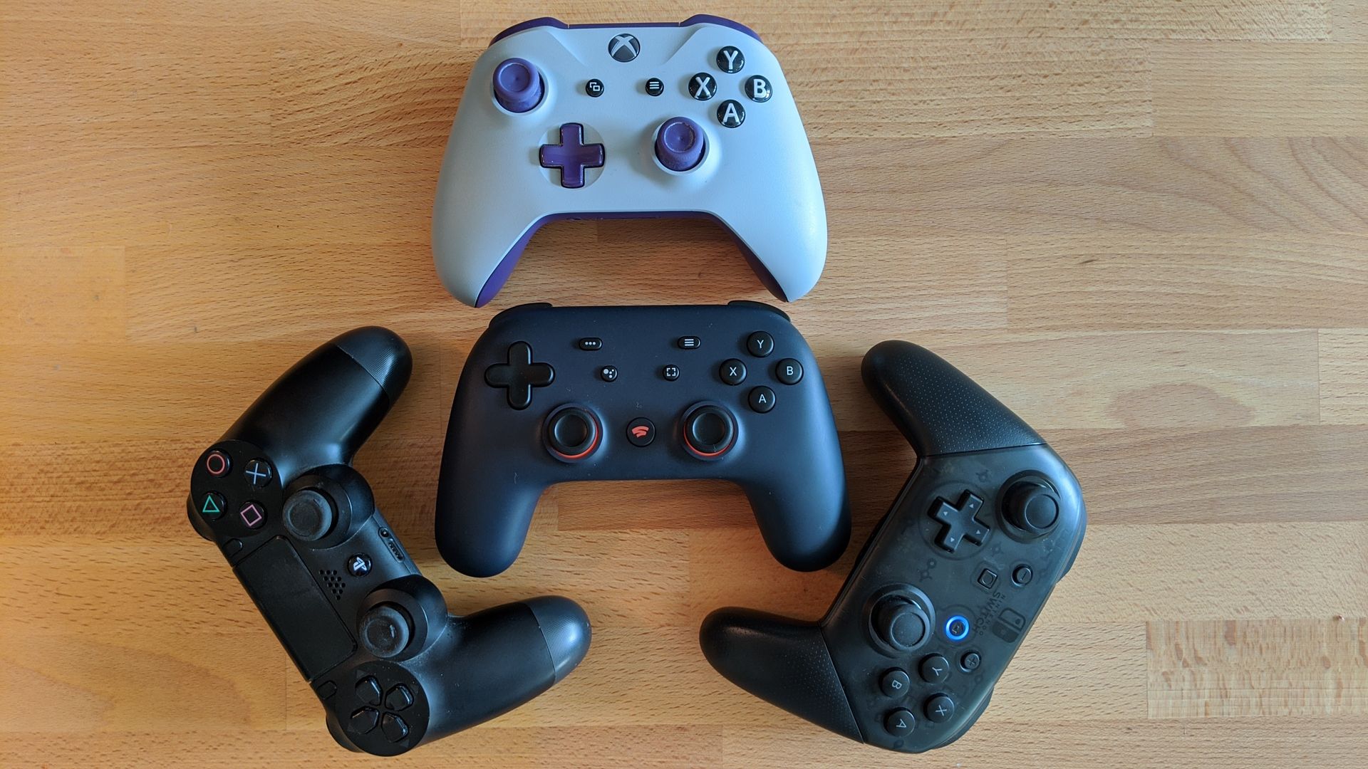 Xbox and Switch controllers arranged in a sort of 